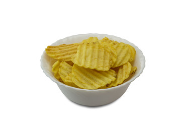 Ribbed yellow potato chips in bowl isolated on white background