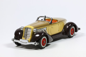 Fototapeta na wymiar Toy Vintage Model Car with Red Wheels
