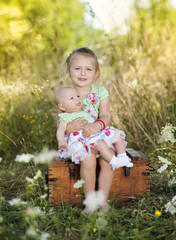 Cute little girl with baby sister