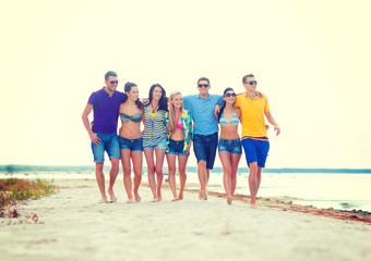 Fototapeta na wymiar group of friends having fun on the beach