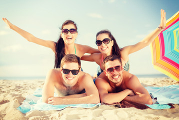 Fototapeta premium group of smiling people having fun on the beach