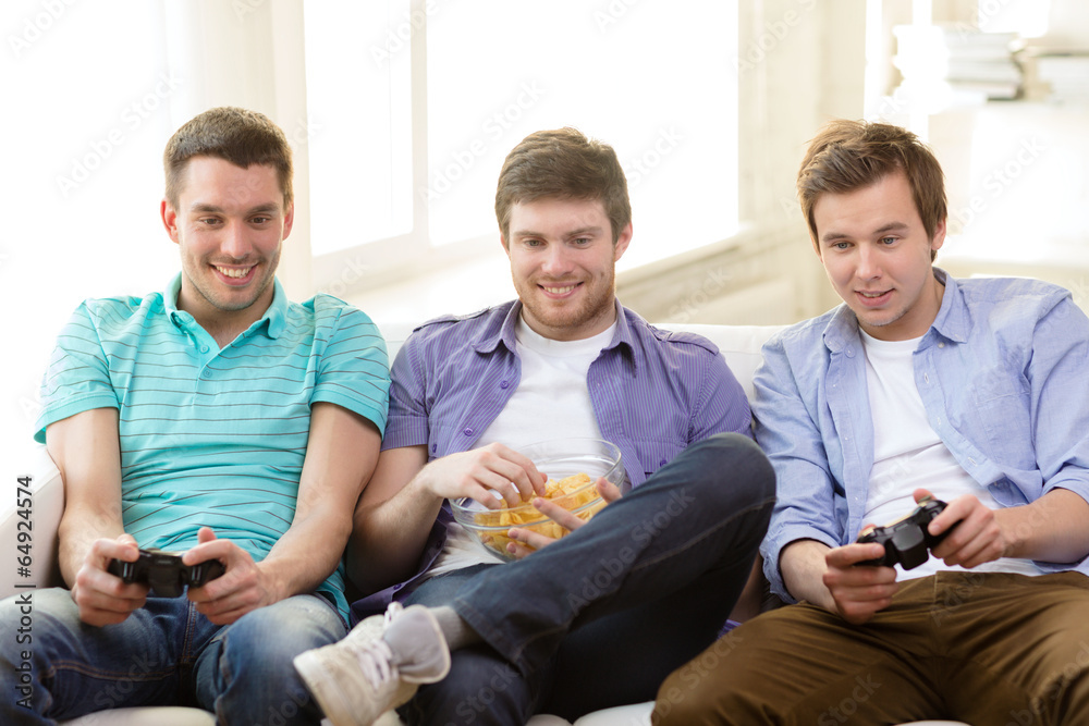 Wall mural smiling friends playing video games at home