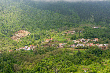 Fototapeta na wymiar A town surrounded with forest on a mountain slope