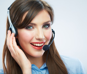 Smiling woman call center operator touching headsed. Close up b
