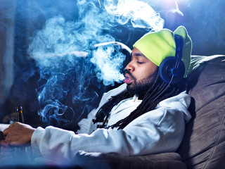 smoking marijuana and drinking beer amid clouds of smoke