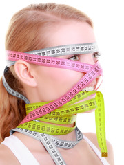 Obsessed fitness woman with a lot of colorful measure tapes