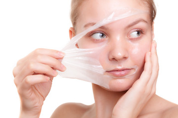 Girl woman in facial peel off mask. Skin care.