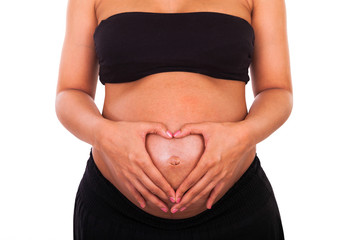 pregnant african american woman hands on belly forming a heart