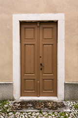 Fototapeta na wymiar Wooden door with stone frame