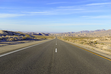 Fototapeta na wymiar Driving on Remote Road in the Desert, Southwestern USA