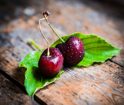 Cherries on rustic wooden background