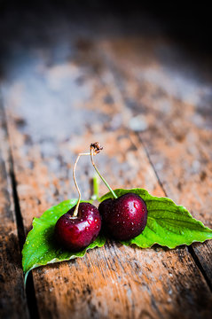 Cherries on rustic wooden background