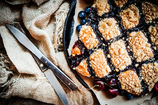 Homemade berry cake on rustic background