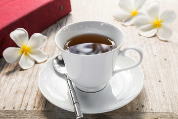 Obraz na płótnie Canvas Cup of tea and book on wooden table
