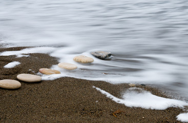 Smooth beach stones in a row