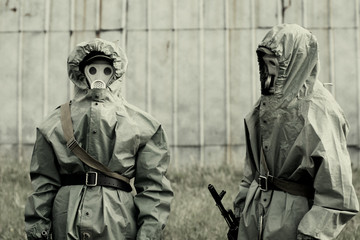 Military mans in protective suit and gas mask outdoors