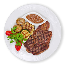 Grilled steak, potatoes and vegetables isolated on white backgro