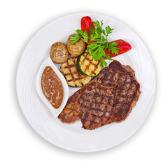 Grilled steak, potatoes and vegetables isolated on white backgro