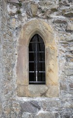 Fototapeta na wymiar Stone close window with bars