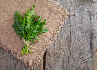 Arugula on wood and cloth.