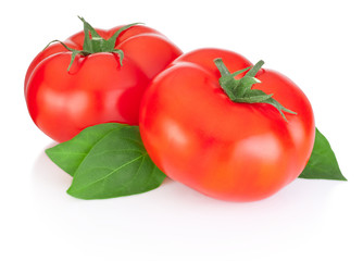 Two red tomatoes and leaves isolated on a white background