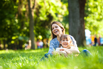 Mother and daughter relaxing in park.