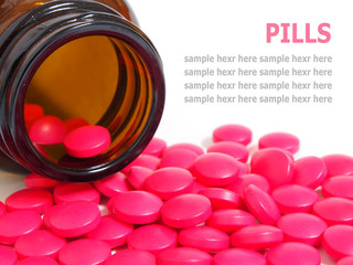 Pills spilling out of a pill bottle isolated on white
