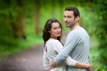 Fototapeta premium Portrait of a young happy couple in the nature