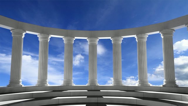 Ancient marble pillars in elliptical arrangement with blue sky