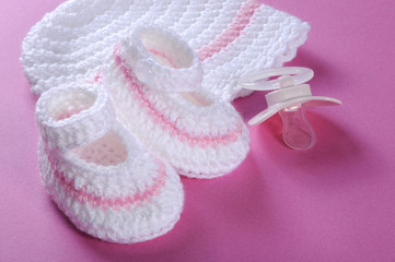 Close up of baby girl bonnet and booties