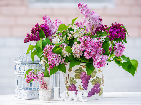 Beautiful still life with lilac and interior decoration details