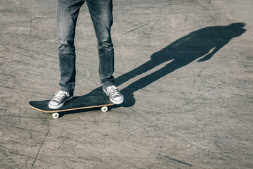Fototapeta na wymiar Legs in sneakers on a skateboard