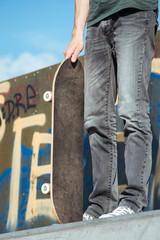 Legs in sneakers on a skateboard