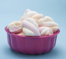 Marshmallows close up on blue background