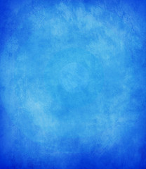 abstract blue background or dark paper with bright center spotli