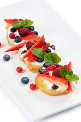 Profiteroles with berries currant , strawberries and blueberries