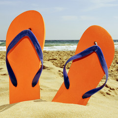 flip-flops on the sand of a beach