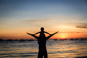 Fototapeta premium happy family on sunset beach