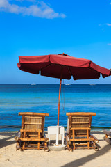 Beach chairs on tropical white sand beach