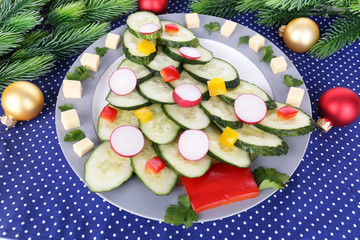 Christmas tree from cucumber on plate on table close-up