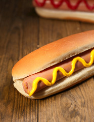 Tasty hot dogs on wooden table