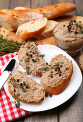 Fresh pate with bread on wooden table