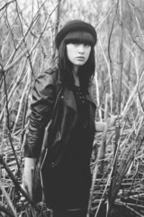 Fashion style portrait of young trendy girl in fashionable hat
