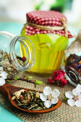 Obraz na płótnie Canvas Assortment of herbs and tea and honey in glass jars