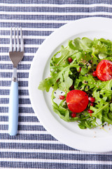 Green salad made with  arugula, tomatoes and sesame