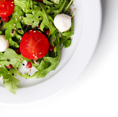 Green salad made with  arugula, tomatoes, cheese mozzarella