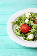 Green salad made with  arugula, tomatoes, cheese mozzarella