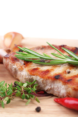 Grilled steak with spices, herbs and vegetables