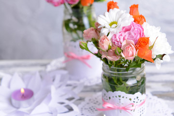 Obraz na płótnie Canvas Beautiful bouquet of bright flowers in jars