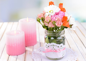 Beautiful bouquet of bright flowers in jars